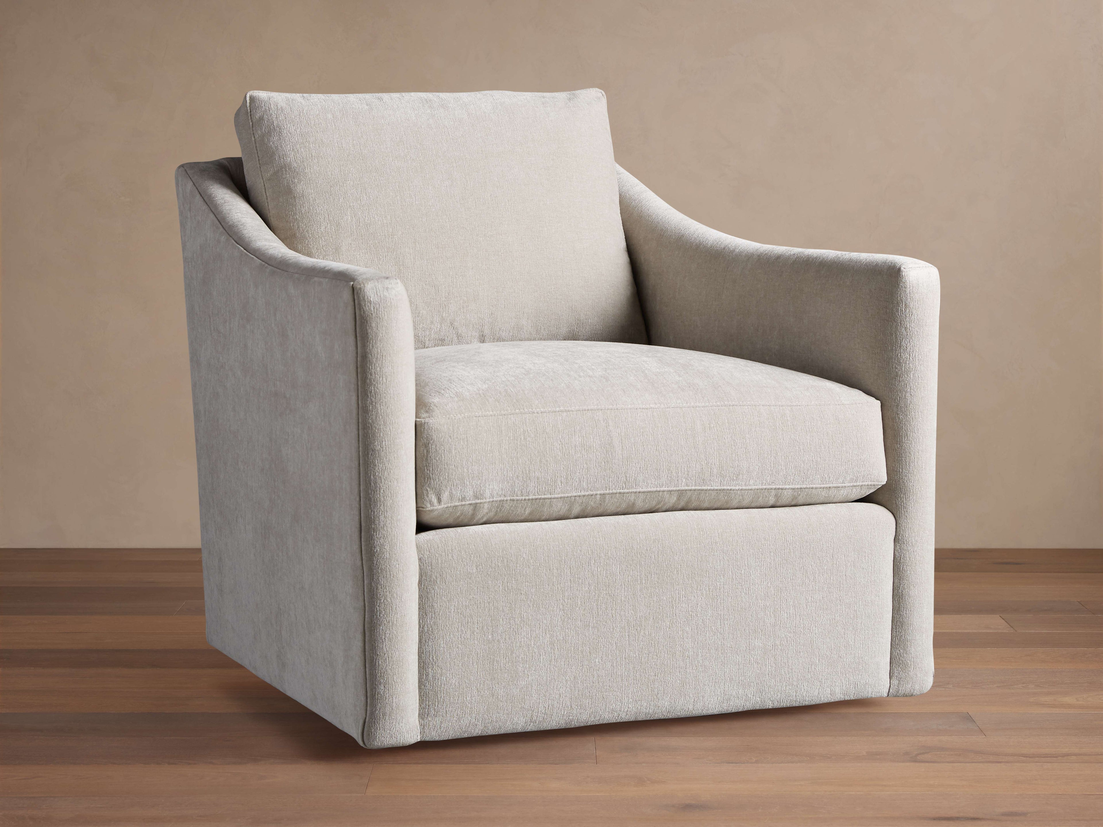 Fauteuil pivotant capitonné avec coussin en duvet